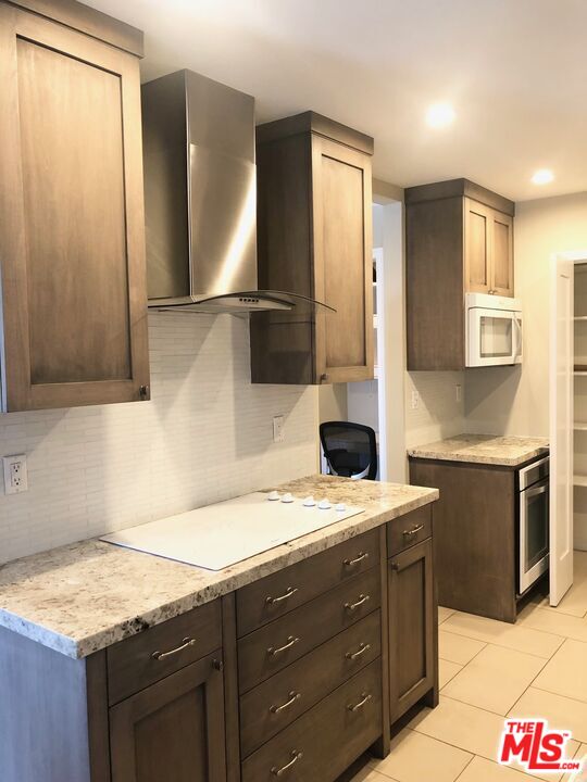 1250 North Kings Road, Unit 506 West Hollywood, CA 90069 - Photo 10 of 22 a bathroom with a granite countertop sink and a mirror
