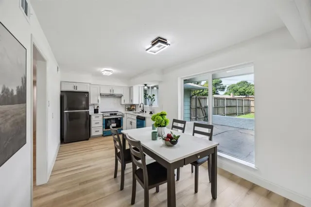 a view of a dining room with furniture window and wooden floor