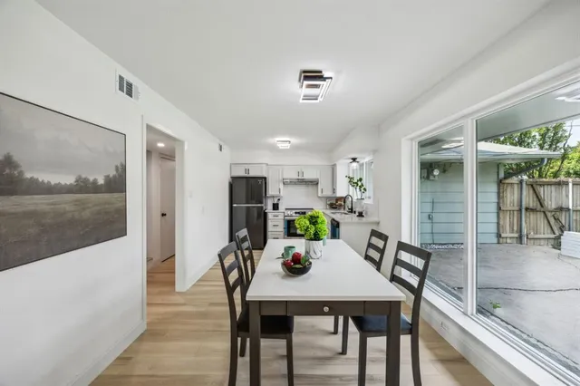 a view of a dining room with furniture and a floor to ceiling window
