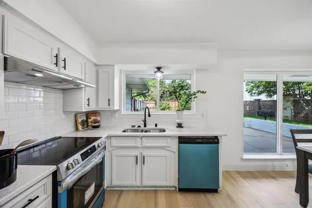 a kitchen with a sink and cabinets