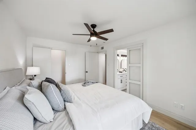 a bedroom with a bed and a ceiling fan