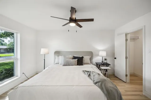 a bedroom with a bed and a window