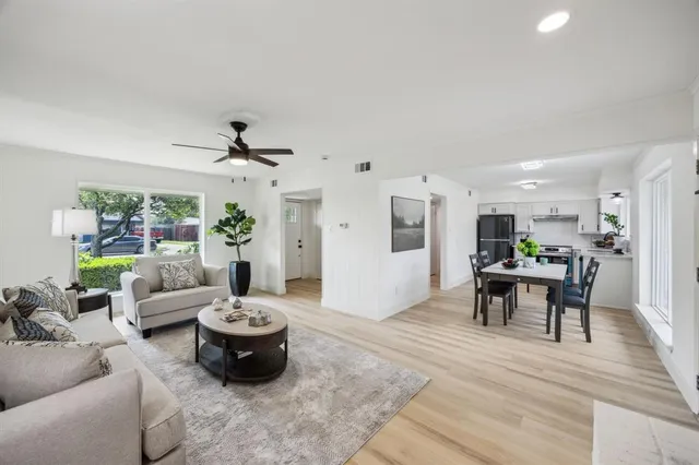 a living room with furniture and a wooden floor