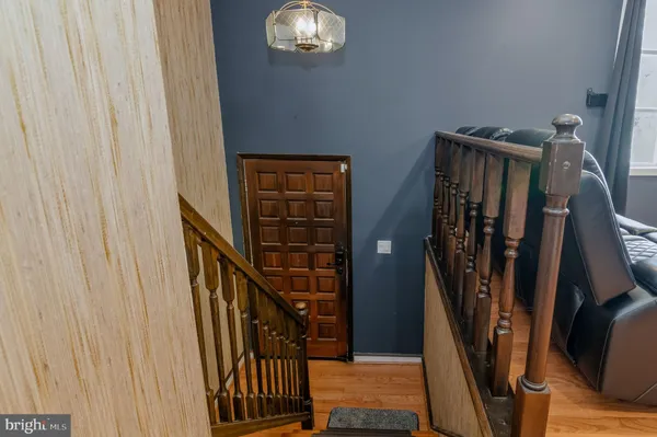 a view of a hallway with wooden walls and stairs