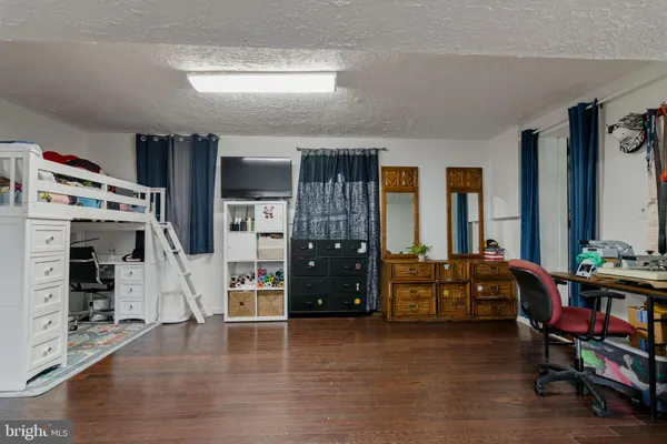 a bedroom with a bed and a dresser in it