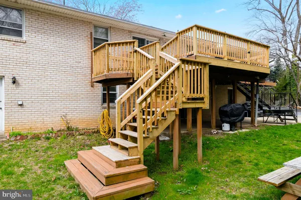 a view of deck with wooden floor and fence with a pot
