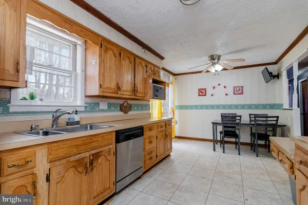 a kitchen with a sink counter top space appliances and a window