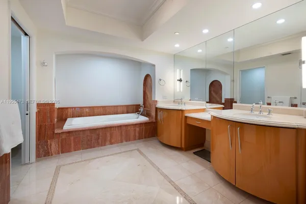 a large bathroom with a double vanity sink mirror and shower