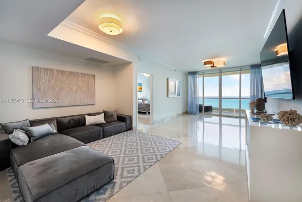 a living room with furniture and a flat screen tv