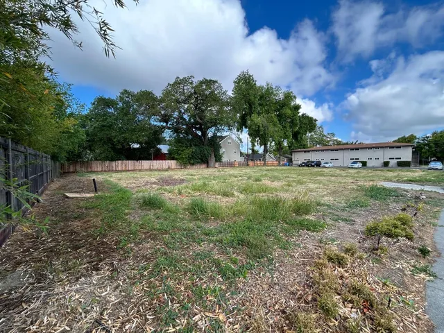 a view of a field with trees in the background