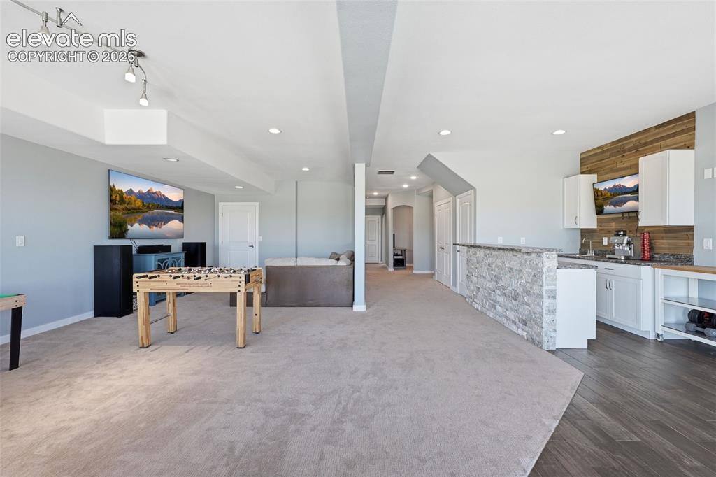 23335 Sanborn Road Calhan, CO 80808 - Photo 20 of 28 Large walkout basement with recreation area and wet bar