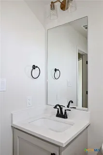 a bathroom with a sink and a mirror