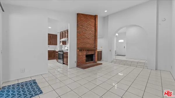 a view of an empty room with a fireplace