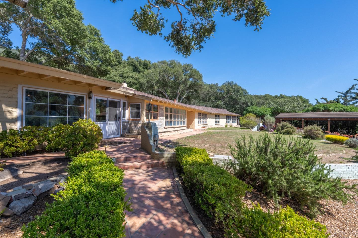 72 Los Laureles Grade Road Carmel Valley, CA 93924 - Photo 28 of 43 a front view of a house with a yard