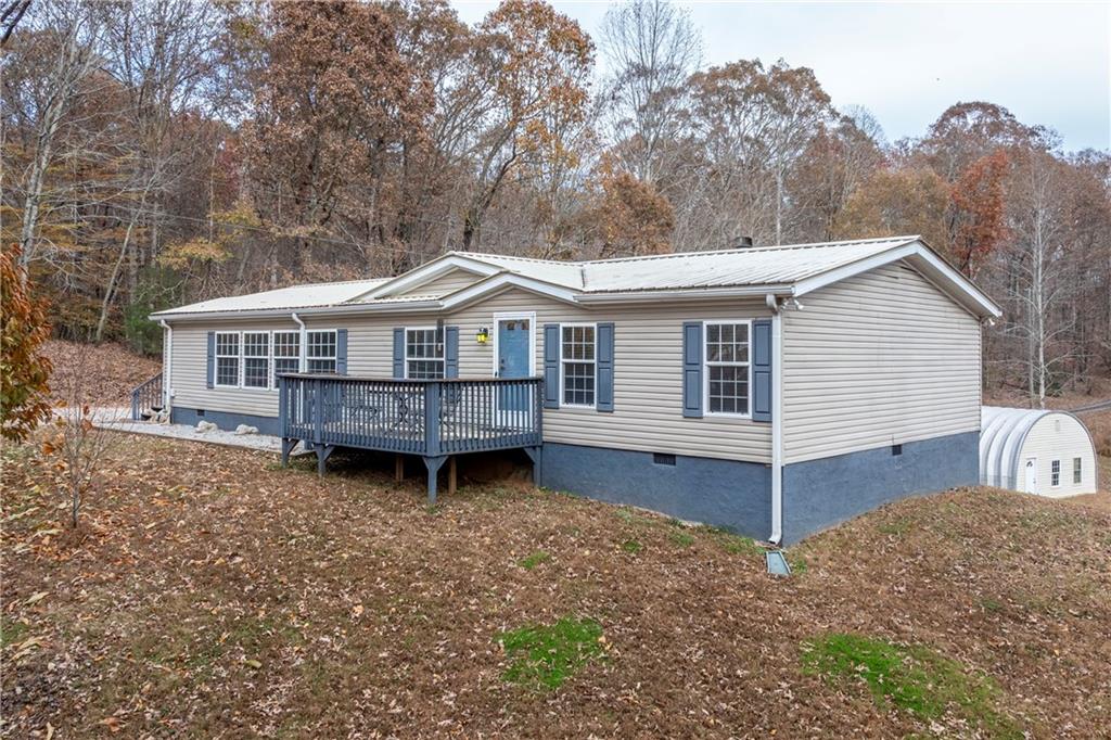 a view of a house with a yard and roof deck