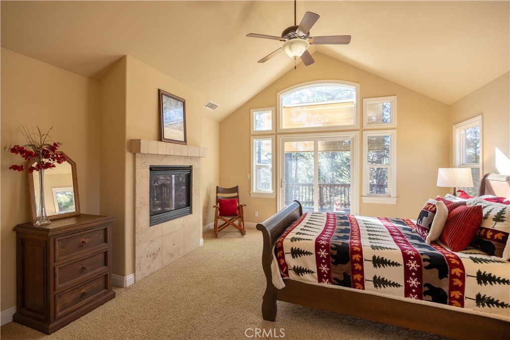 173 Grizzly Road Lake Arrowhead, CA 92352 - Photo 14 of 40 a bed room with furniture and a fireplace