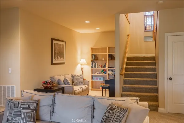 a living room with furniture and a potted plant