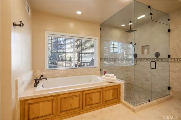 a spacious bathroom with a tub shower and sink