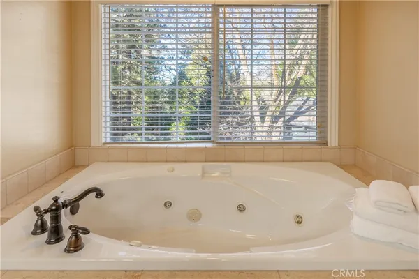 a bathroom with bathtub and window