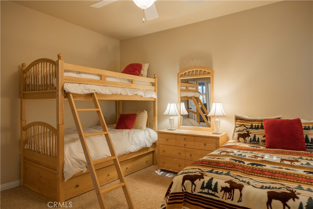 173 Grizzly Road Lake Arrowhead, CA 92352 - Photo 35 of 40 a bedroom with a bed and wooden floor