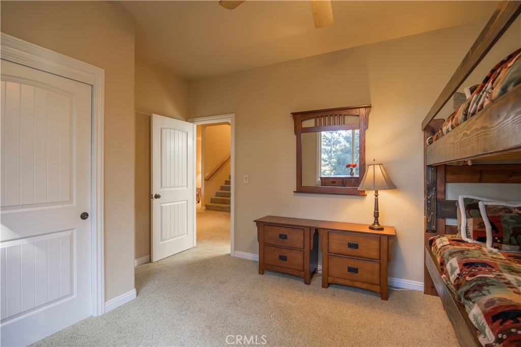 173 Grizzly Road Lake Arrowhead, CA 92352 - Photo 38 of 40 a view of a bedroom with furniture and mirror