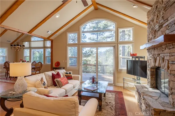 a living room with furniture a large window with outer view