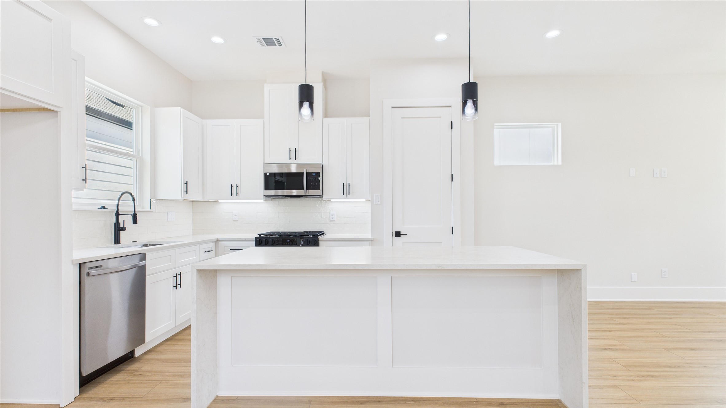 4506 Robertson Street Houston, TX 77009 - Photo 10 of 25 a kitchen with stainless steel appliances granite countertop a sink a stove and a refrigerator