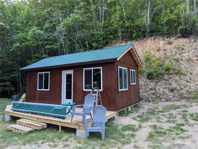 a backyard of a house with fountain table and chairs