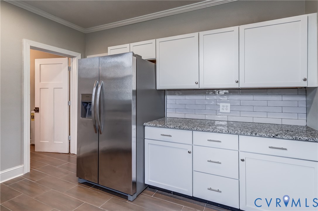 418 4th Street West Point, VA 23181 - Photo 16 of 36 a kitchen with granite countertop white cabinets and stainless steel appliances