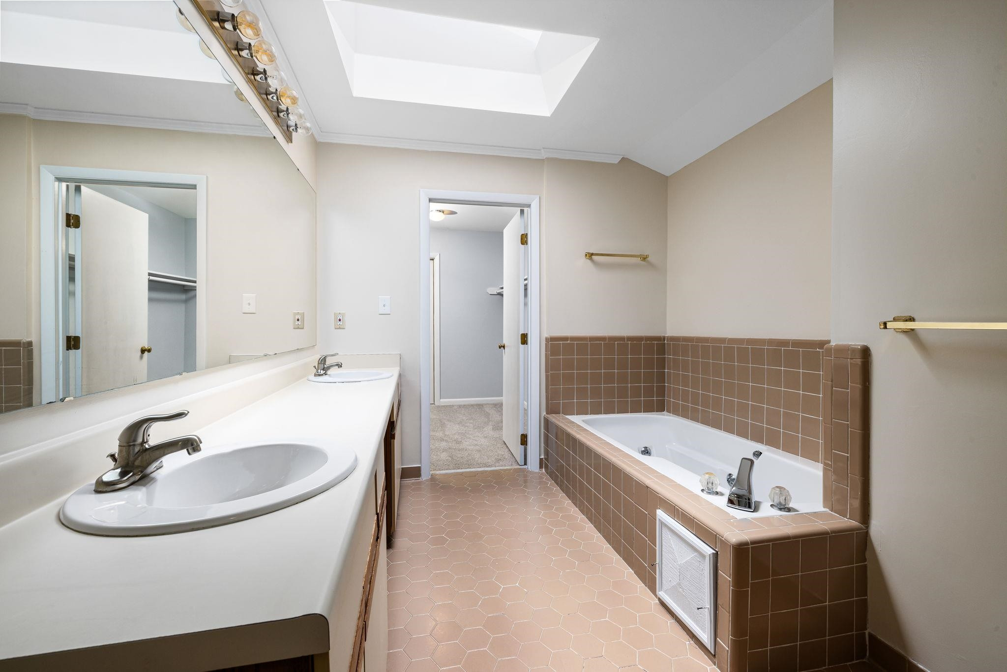 8028 Mourning Dove Road Raleigh, NC 27615 - Photo 17 of 35 a bathroom with a tub sink and mirror