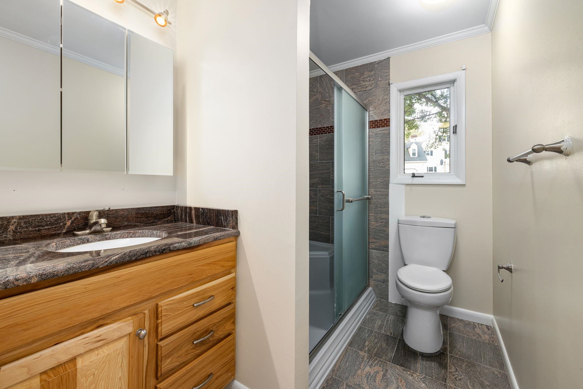 8028 Mourning Dove Road Raleigh, NC 27615 - Photo 21 of 35 a bathroom with a granite countertop sink toilet and shower