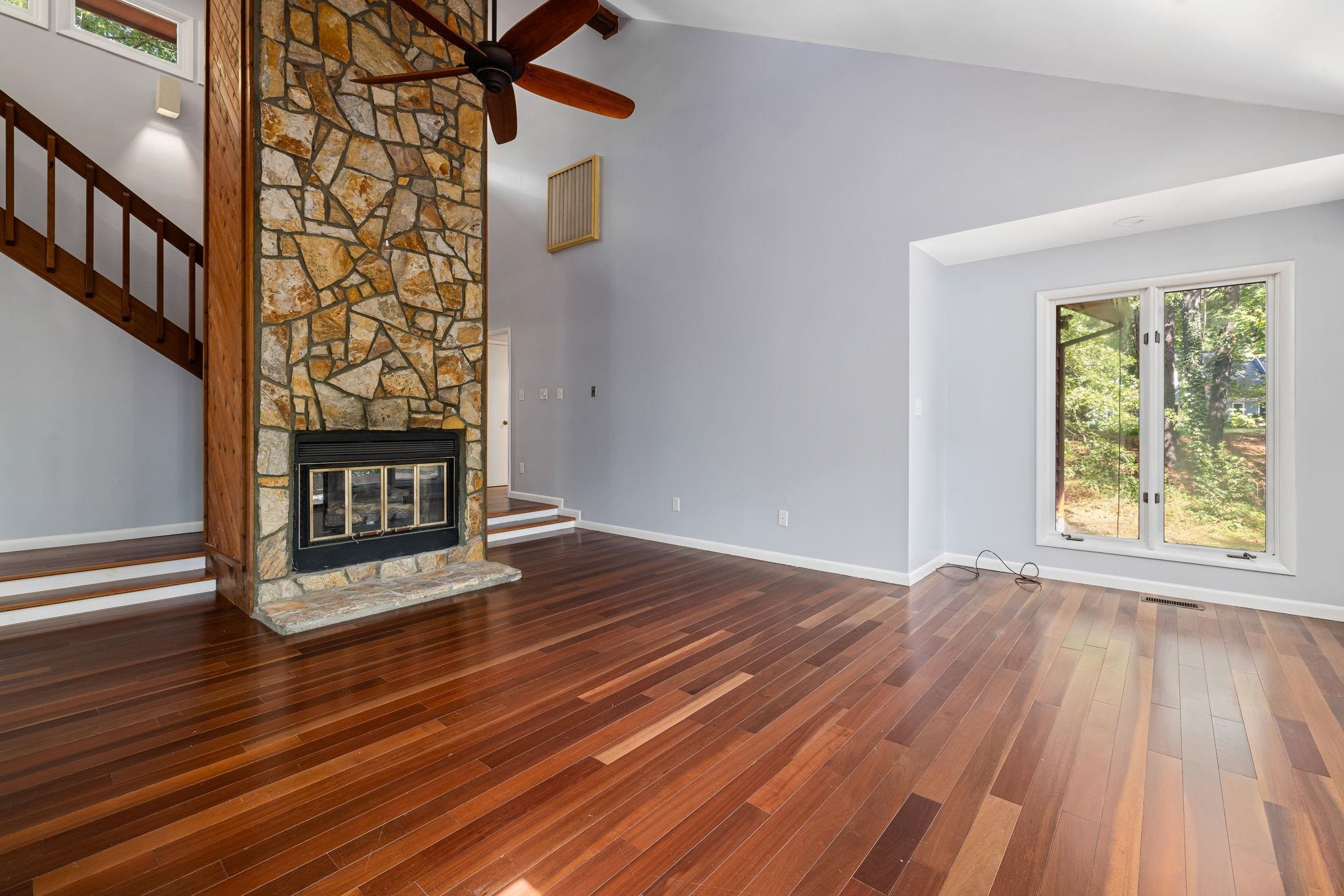 8028 Mourning Dove Road Raleigh, NC 27615 - Photo 7 of 35 a view of an empty room with wooden floor fireplace and a window