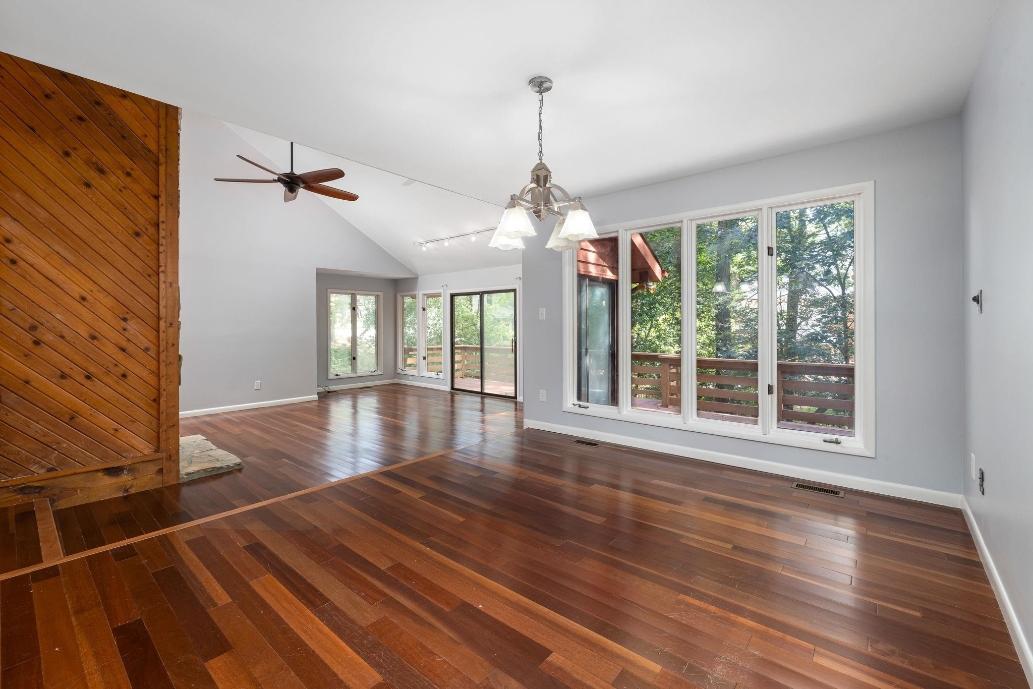8028 Mourning Dove Road Raleigh, NC 27615 - Photo 8 of 35 a view of empty room with wooden floor and fan