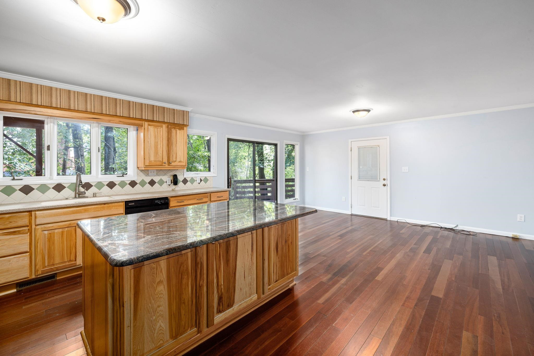 8028 Mourning Dove Road Raleigh, NC 27615 - Photo 10 of 35 a kitchen with stainless steel appliances granite countertop a sink a stove and wooden floors