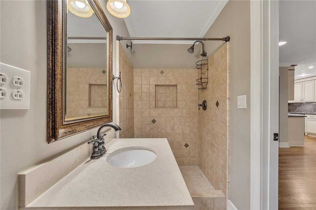 2290 Beaver Creek Road Smyrna, GA 30080 - Photo 19 of 66 a bathroom with a granite countertop sink a mirror a vanity and shower