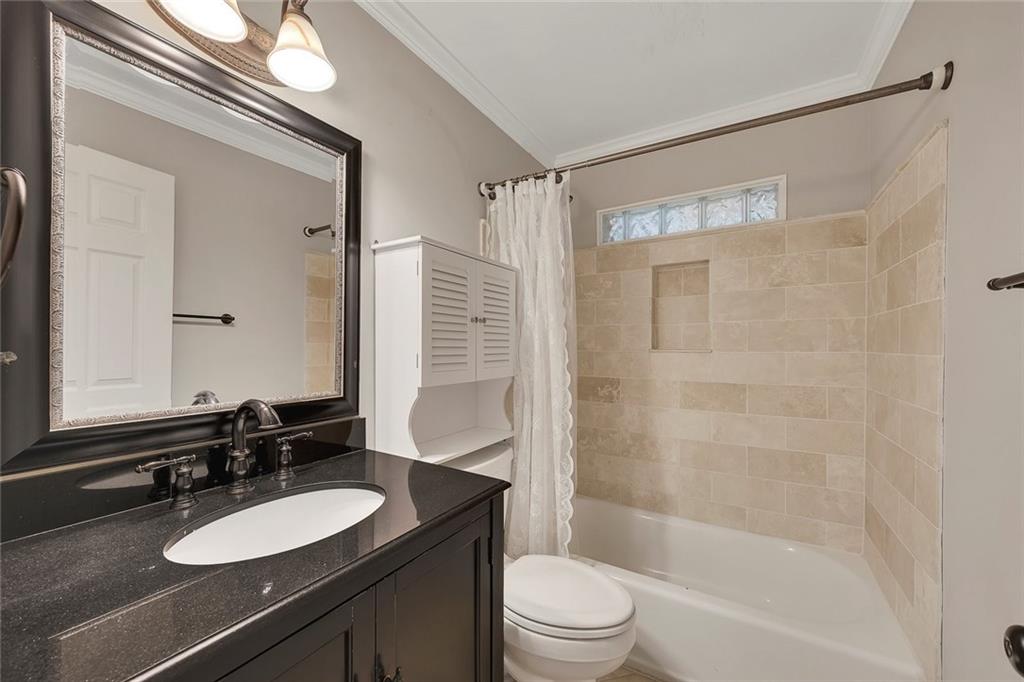 2290 Beaver Creek Road Smyrna, GA 30080 - Photo 34 of 66 a bathroom with a sink a toilet a mirror and shower