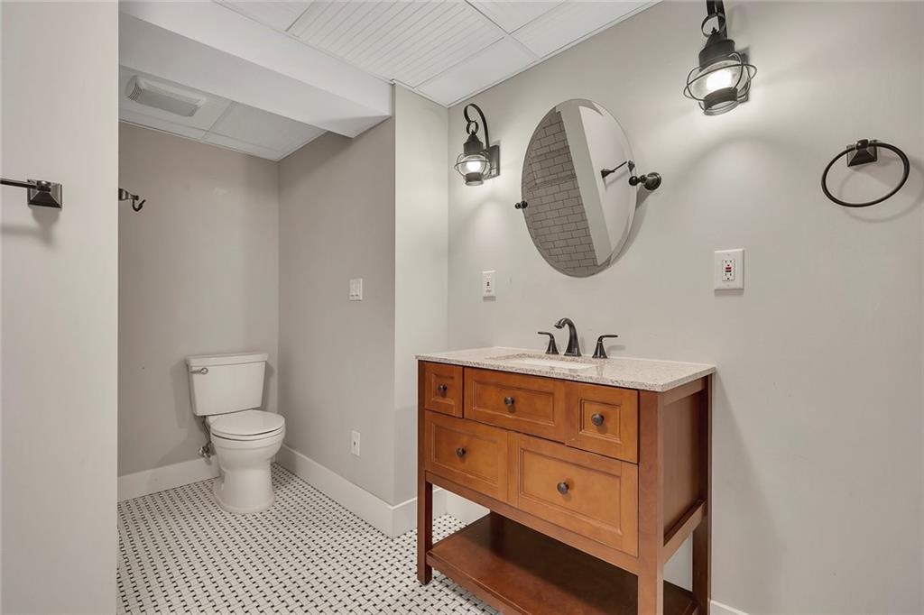 2290 Beaver Creek Road Smyrna, GA 30080 - Photo 48 of 66 a bathroom with a toilet a sink and mirror