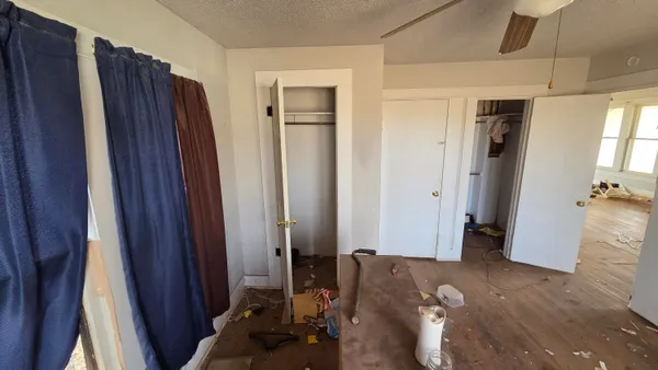 a bed room with a bed and a mirror