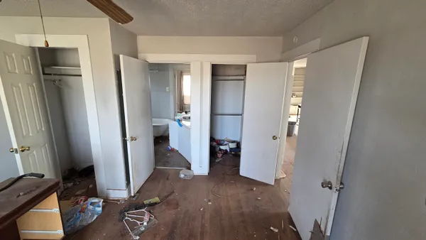 a view of hallway with wooden floor