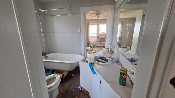 a bathroom with a sink a toilet and shower curtain