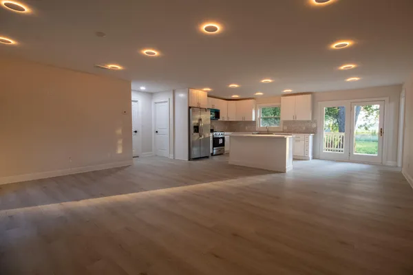 a view of a kitchen with a sink and a refrigerator