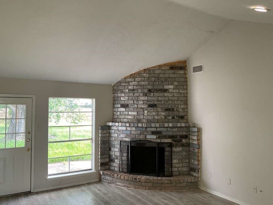 117 Bastrop Street Angleton, TX 77515 - Photo 1 of 15 an empty room with windows and fireplace