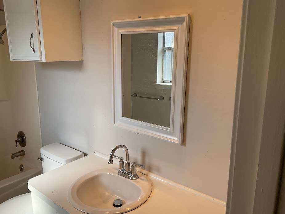 117 Bastrop Street Angleton, TX 77515 - Photo 6 of 15 a bathroom with a sink and a mirror