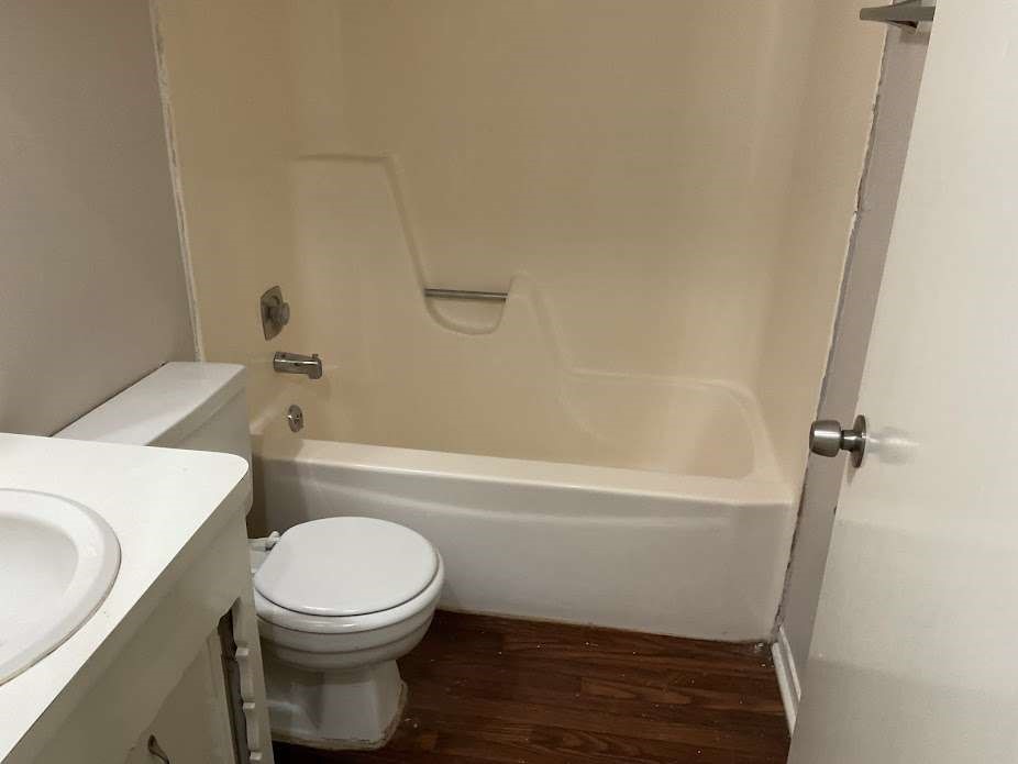 117 Bastrop Street Angleton, TX 77515 - Photo 7 of 15 a bathroom with a toilet and a bathtub