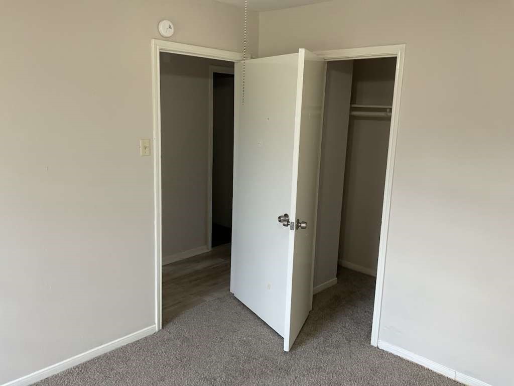 117 Bastrop Street Angleton, TX 77515 - Photo 9 of 15 a view of an empty room with closet and wooden floor