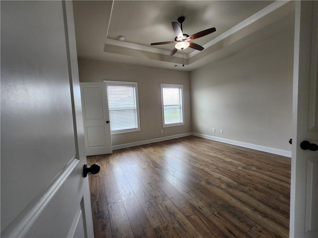 1323 Faircrest Way Suwanee, GA 30024 - Photo 11 of 16 wooden floor in an empty room with a window
