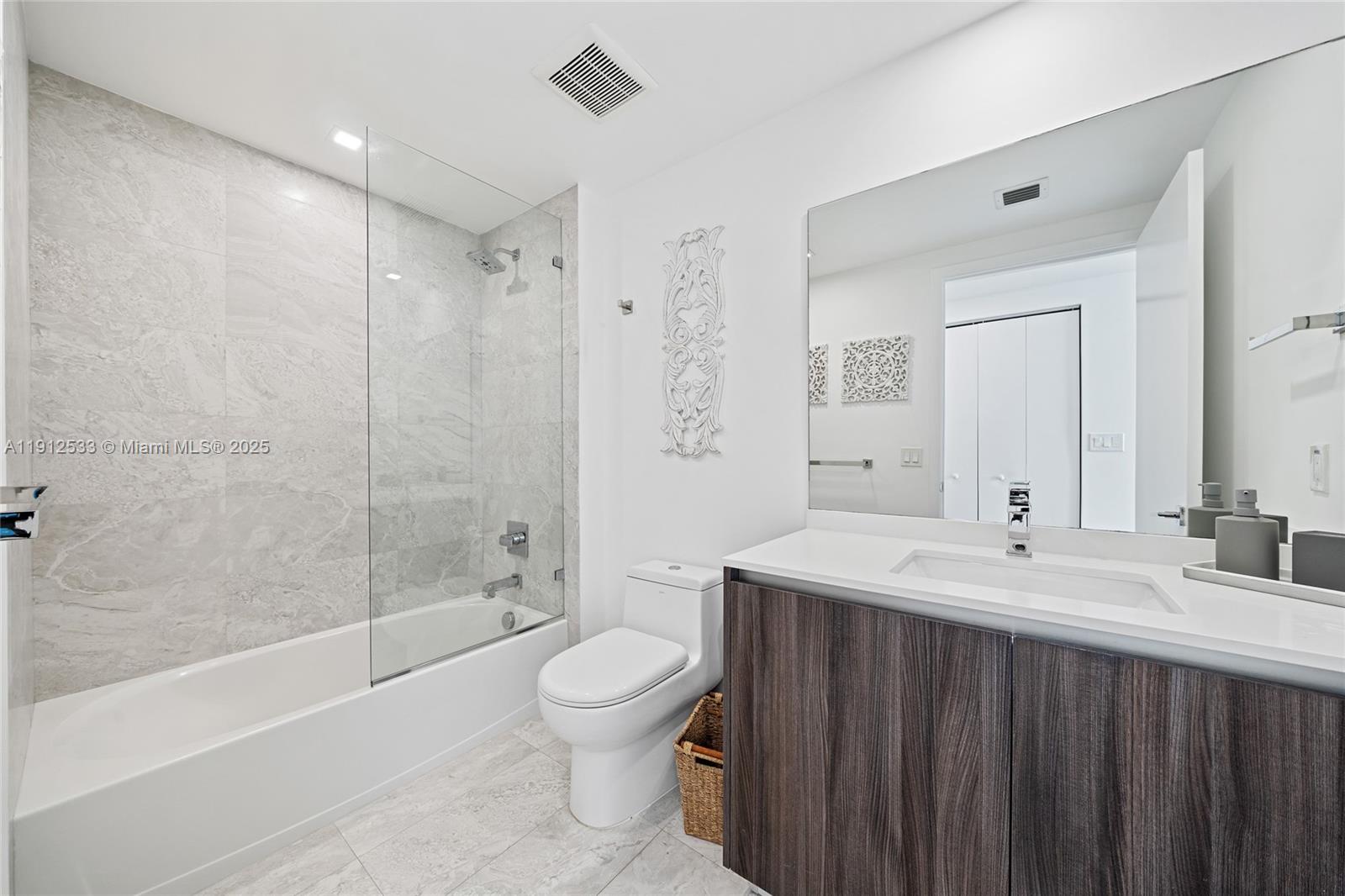 488 Northeast 18th Street, Unit 4612 Miami, FL 33132 - Photo 12 of 42 a bathroom with a sink a toilet and shower