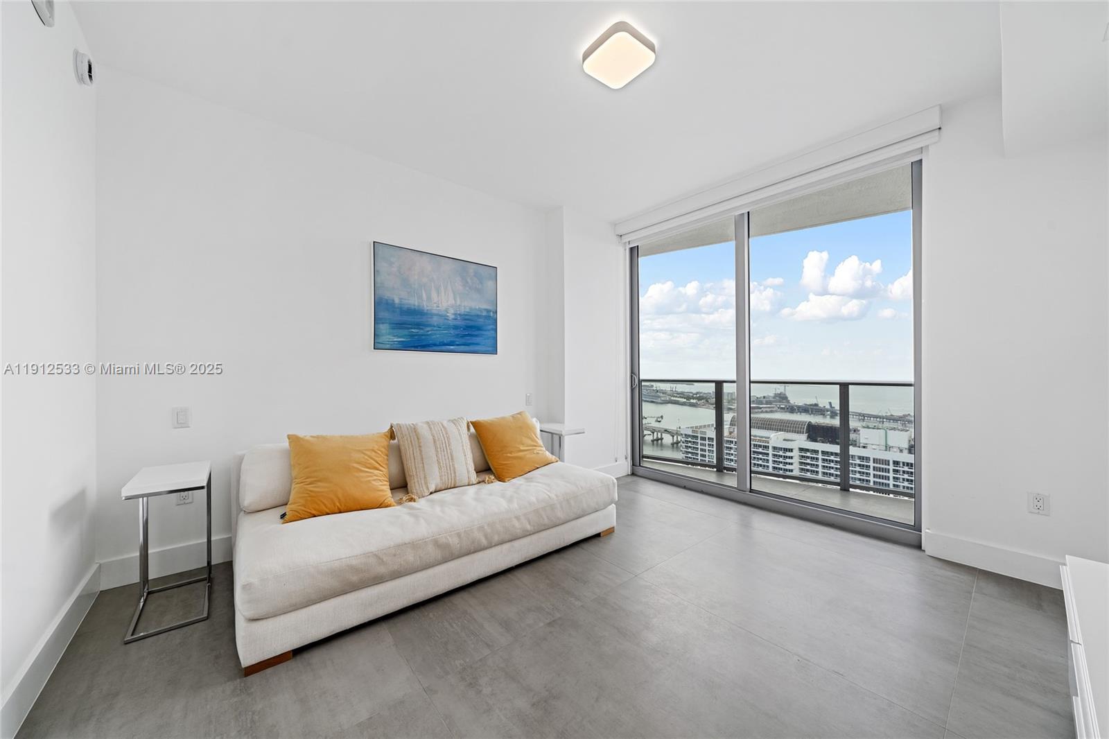 488 Northeast 18th Street, Unit 4612 Miami, FL 33132 - Photo 13 of 42 a living room with furniture and a floor to ceiling window
