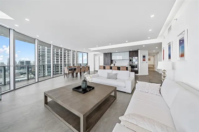 a view of kitchen with kitchen island and stainless steel appliances