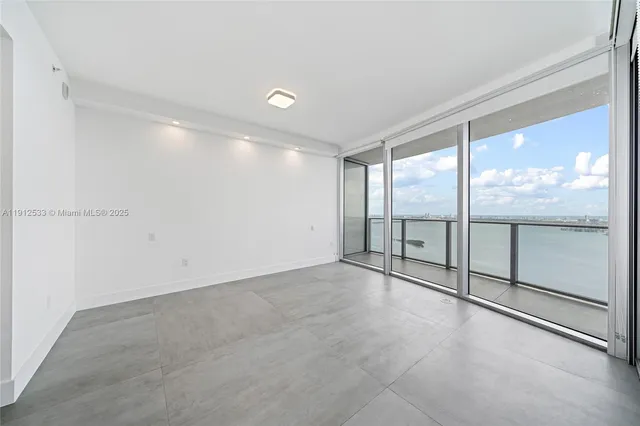 an empty room with sliding door and city view